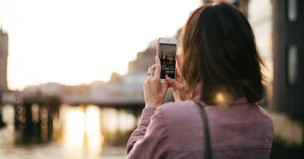 Woman Wearing Maroon Long-sleeved Shirt Holding Smartphone