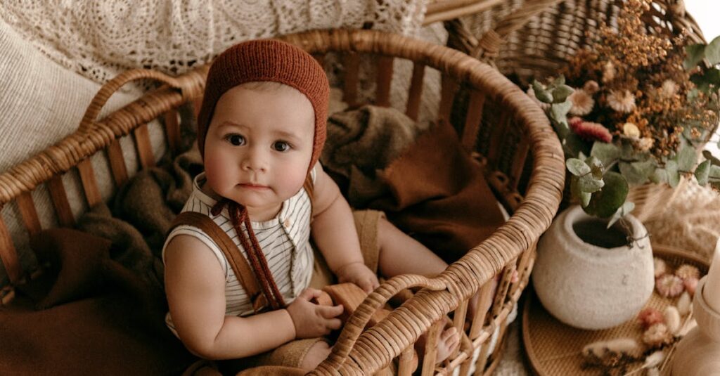 A Baby Sitting in a Basket with Autumnal Decorations