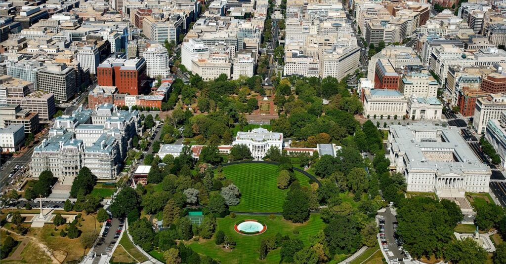 A stunning aerial view of The White House surrounded by downtown Washington D.C.'s architecture and green spaces.