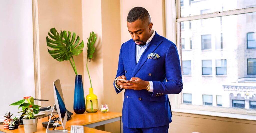 Businessman in a blue suit using a smartphone at his office desk with city view.