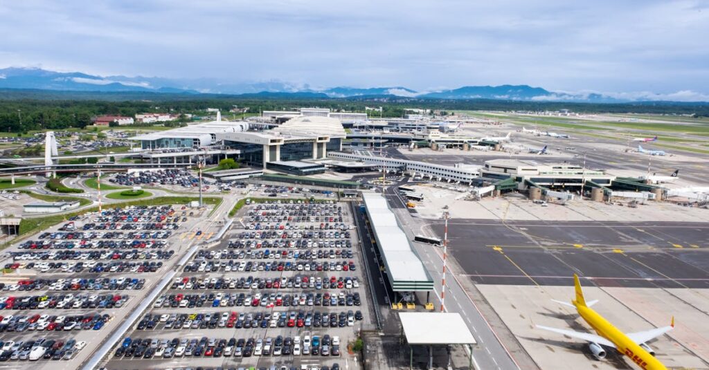 Dynamic aerial perspective of Milano Malpensa Airport showcasing terminal activity and bustling airplane operations.