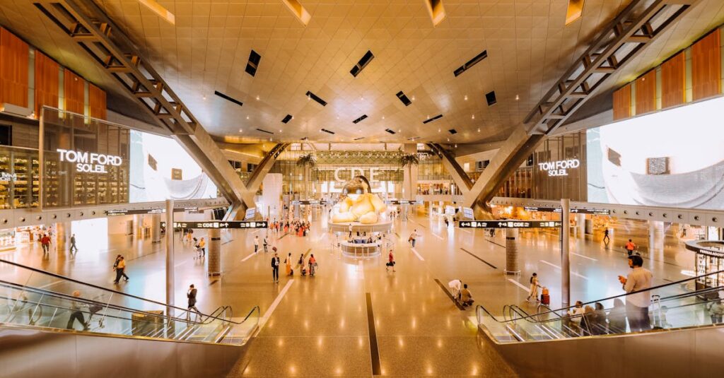 View of a spacious modern terminal interior with travelers and architectural features.