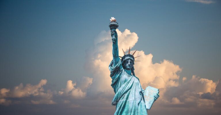 Iconic Statue of Liberty with majestic clouds in New York, USA. Perfect travel destination image.