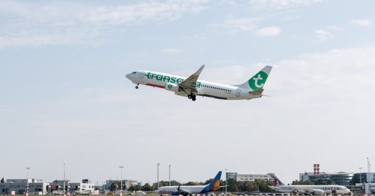 A commercial airplane takes off from Prague airport under a clear sky.