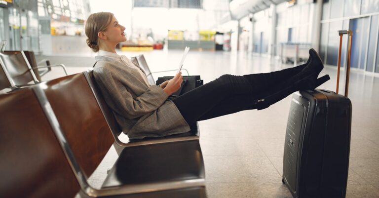 Woman Sitting On A Chair Inside An Airport