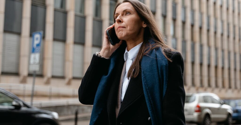 Confident businesswoman talking on the phone in the city street.