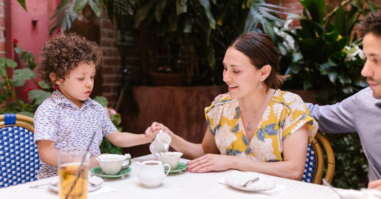 Parents with a Little Son Sitting at the Table in a Restaurant