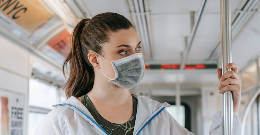 An adult woman wearing a face mask rides public transportation, focusing on safety and protection.