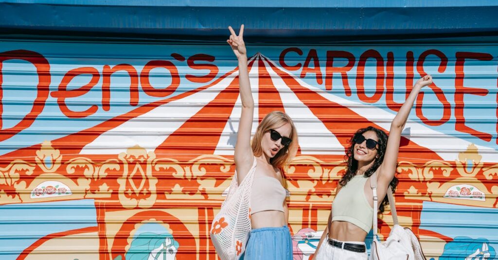 Two stylish women pose happily in front of Deno's Carousel, showcasing summer fashion vibes.