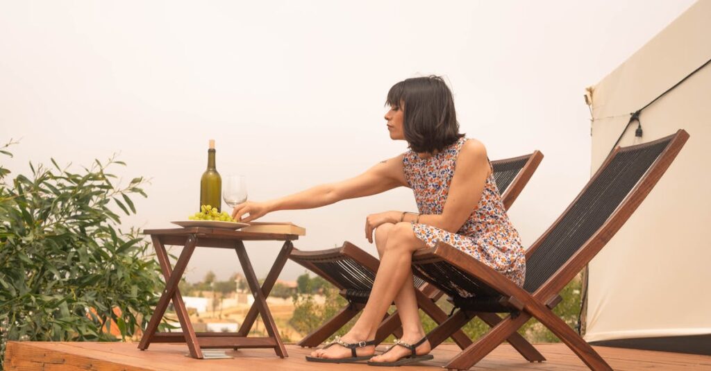 Woman enjoying a relaxing day with wine and grapes outdoors during summer.