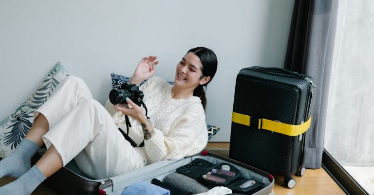 A Woman Sitting on a Luggage Holding a Camera