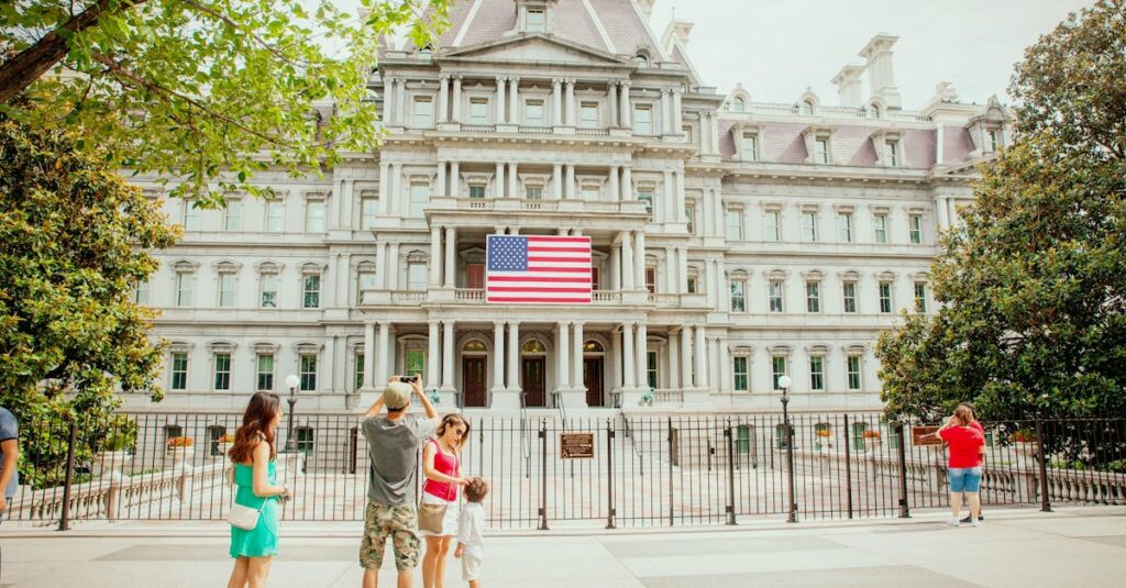 Tourists explore the historic Eisenhower Executive Office Building in Washington, DC, under a bright day.