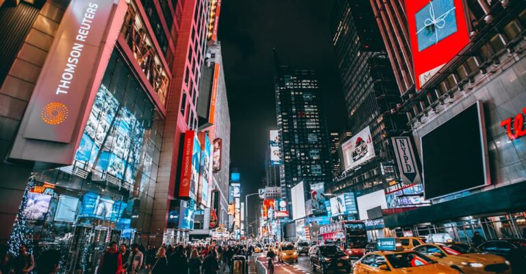 Bustling evening scene in New York City's iconic Times Square, showcasing bright lights and lively atmosphere.