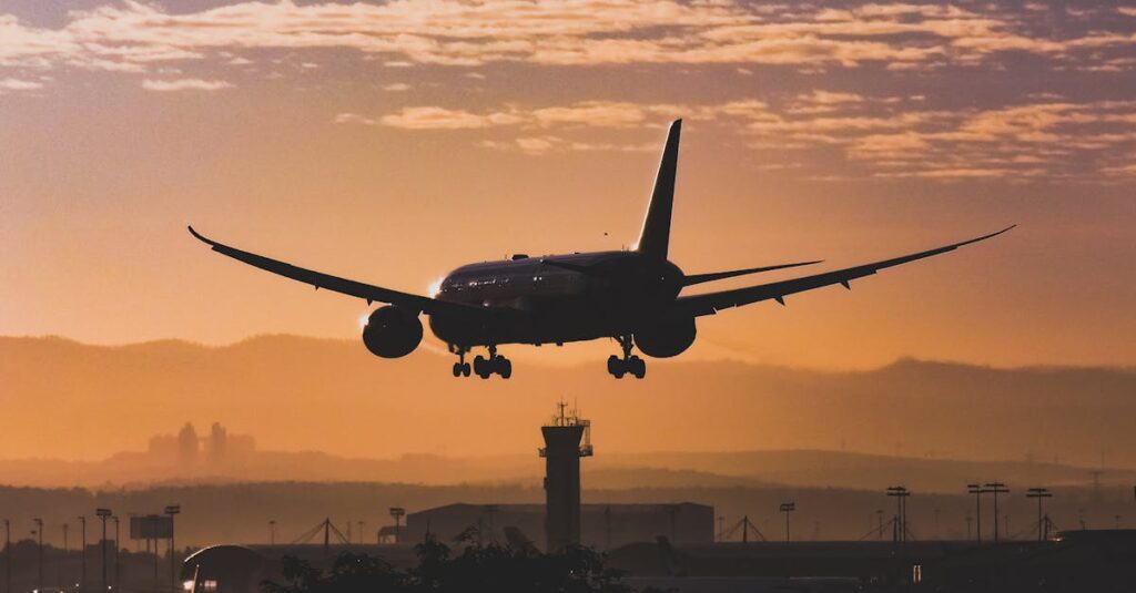 Silhouette of an airplane landing at sunset in Tel Aviv, with a beautiful golden sky.