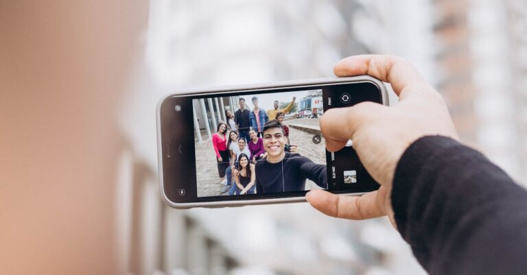 A group of friends taking a selfie with a smartphone on the streets of New York City.