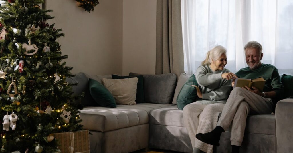 Elderly couple enjoying a peaceful Christmas moment together by the tree.