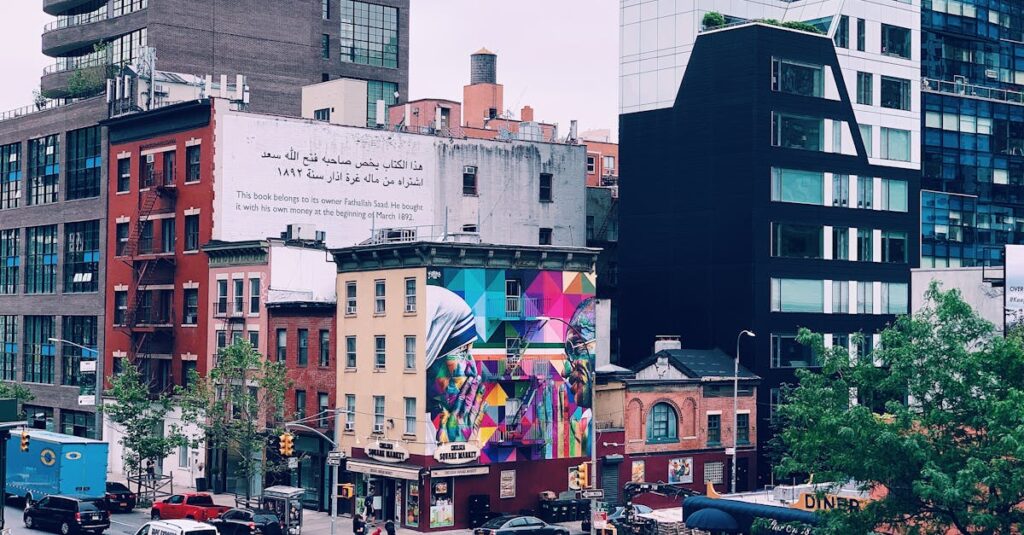 Colorful cityscape of New York with urban murals, modern architecture, and bustling street life.