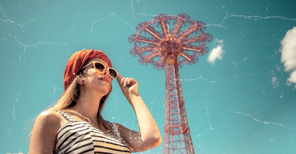 Fashionable woman poses at Coney Island with iconic Parachute Jump in the background.