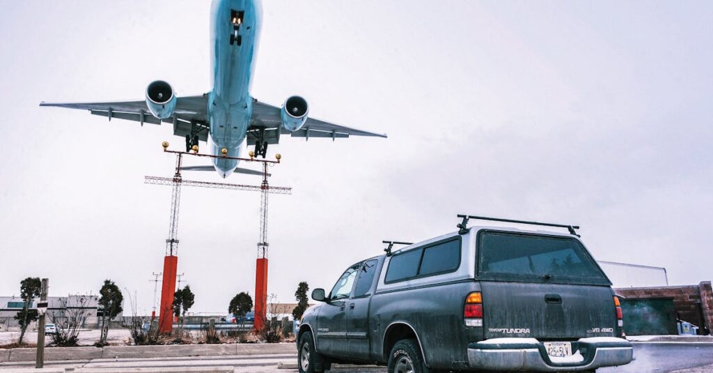 A striking image capturing an airplane landing closely over a parked truck on a tarmac.