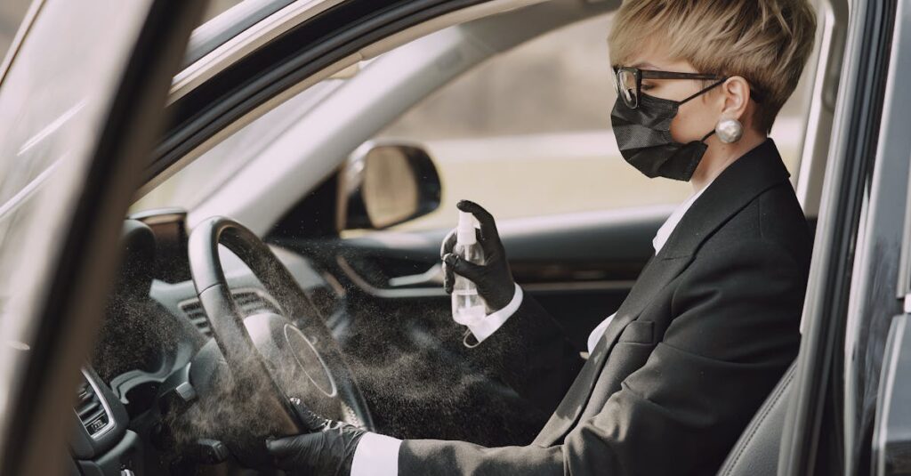 Woman disinfects steering wheel to ensure health and safety in vehicle.