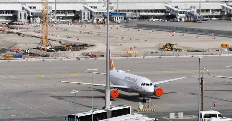 Airbus at Munich Airport alongside ongoing construction work, showcasing modern aviation infrastructure.