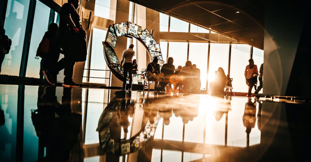 Silhouette of people enjoying sunset views from a modern skyscraper in New York City.