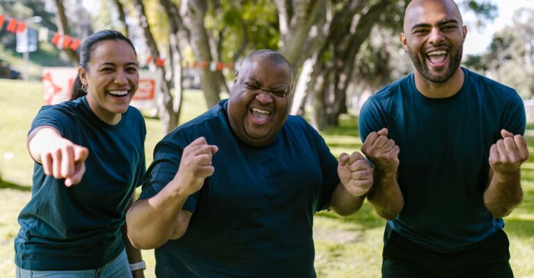 A diverse group of adults enjoying a successful outdoor team-building event in a park.