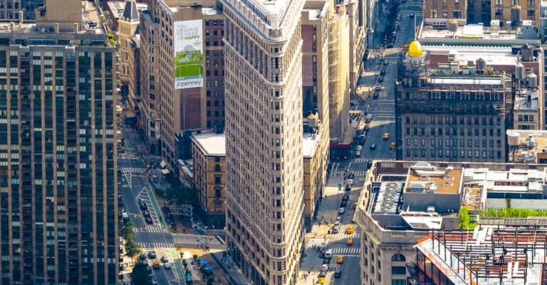 Stunning aerial view of the iconic Flatiron Building surrounded by Manhattan's bustling cityscape.