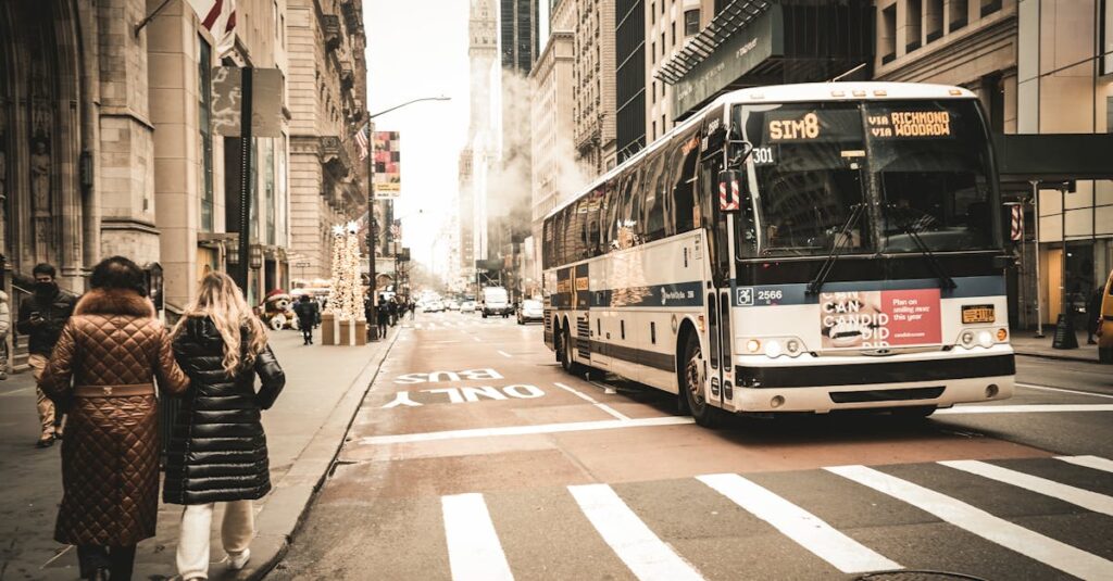 A downtown scene featuring a city bus, pedestrians, and urban architecture.