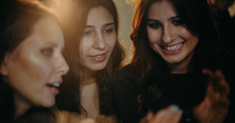 Three young women enjoying a festive night out, captured in a candid moment full of joy and connection.