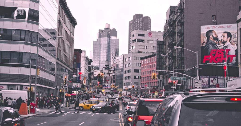 Lively city street in New York with bustling traffic and urban buildings during the day.