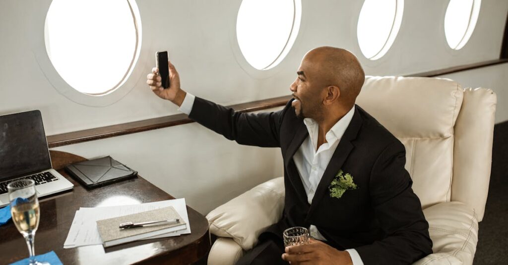 A businessman enjoying a drink and video call in a first-class private jet.