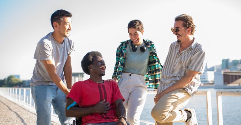 A joyful group of diverse friends sharing a moment by the waterfront.