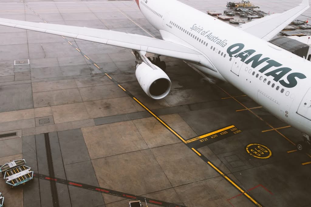 Upper Car Service NYC for Airport Transfers: Honest 2026 Family Guide 17 Qantas commercial airplane parked on the tarmac at Melbourne Airport, Australia.
