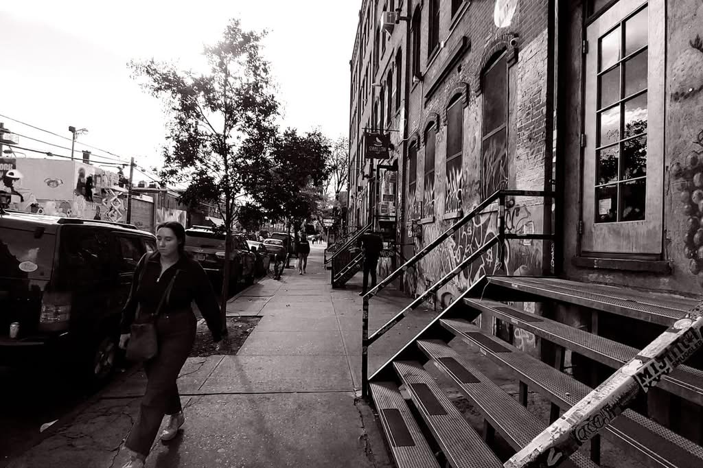 Monochrome street photo showcasing graffiti and architecture in Brooklyn, NY.