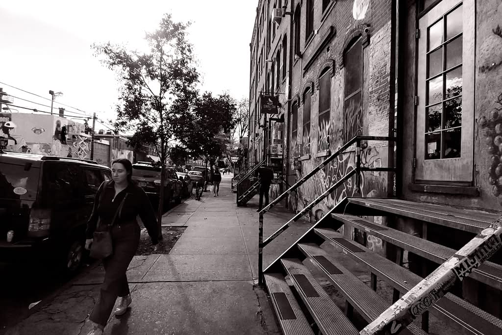 Monochrome street photo showcasing graffiti and architecture in Brooklyn, NY.
