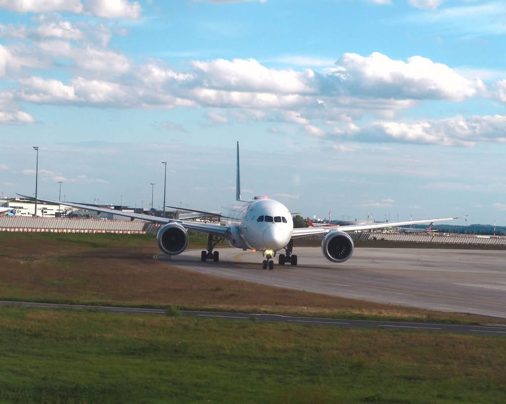 Eco Friendly Transportation to JFK: The Honest 2026 Family Comparison 19 A large airplane taxiing on the runway at Charles de Gaulle Airport, Roissy-en-France, France.