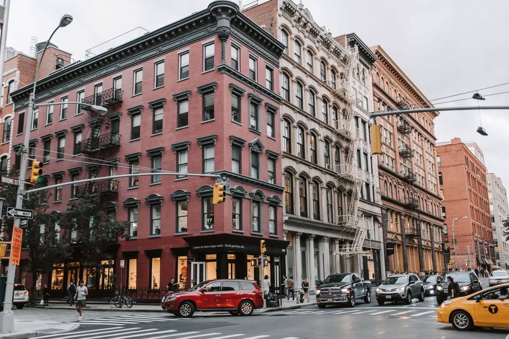 Dynamic street scene in Soho, NYC showcasing classic architecture and urban life.